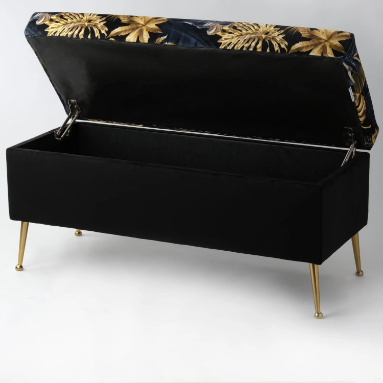Stylish black pouffe with storage and leaf upholstery, on golden metal legs