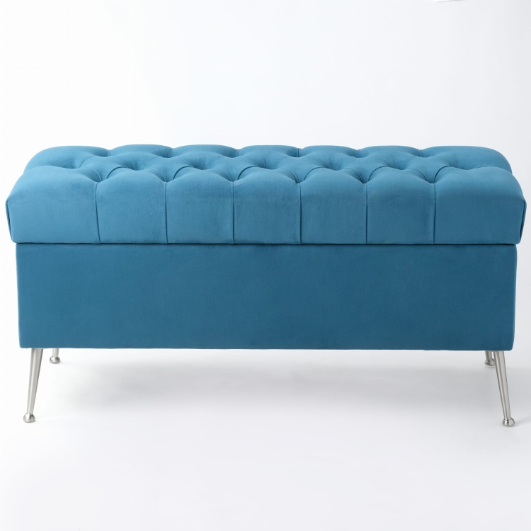 Modern blue quilted pouffe with storage, standing on metal legs
