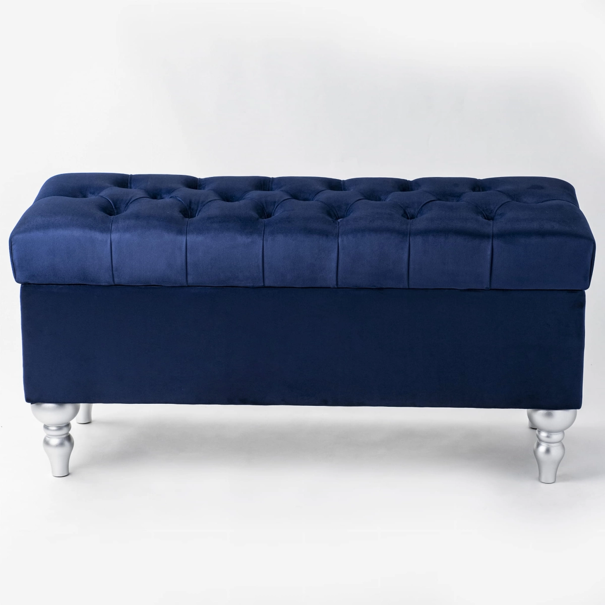 Navy blue pouffe with storage and quilting, ideal for modern interiors