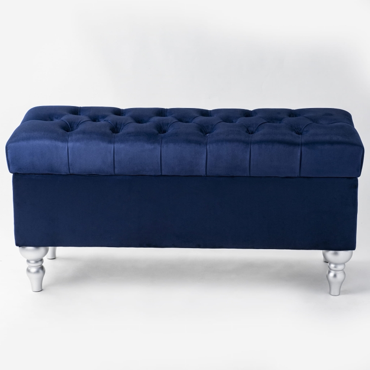 Navy blue pouffe with storage and quilting, ideal for modern interiors