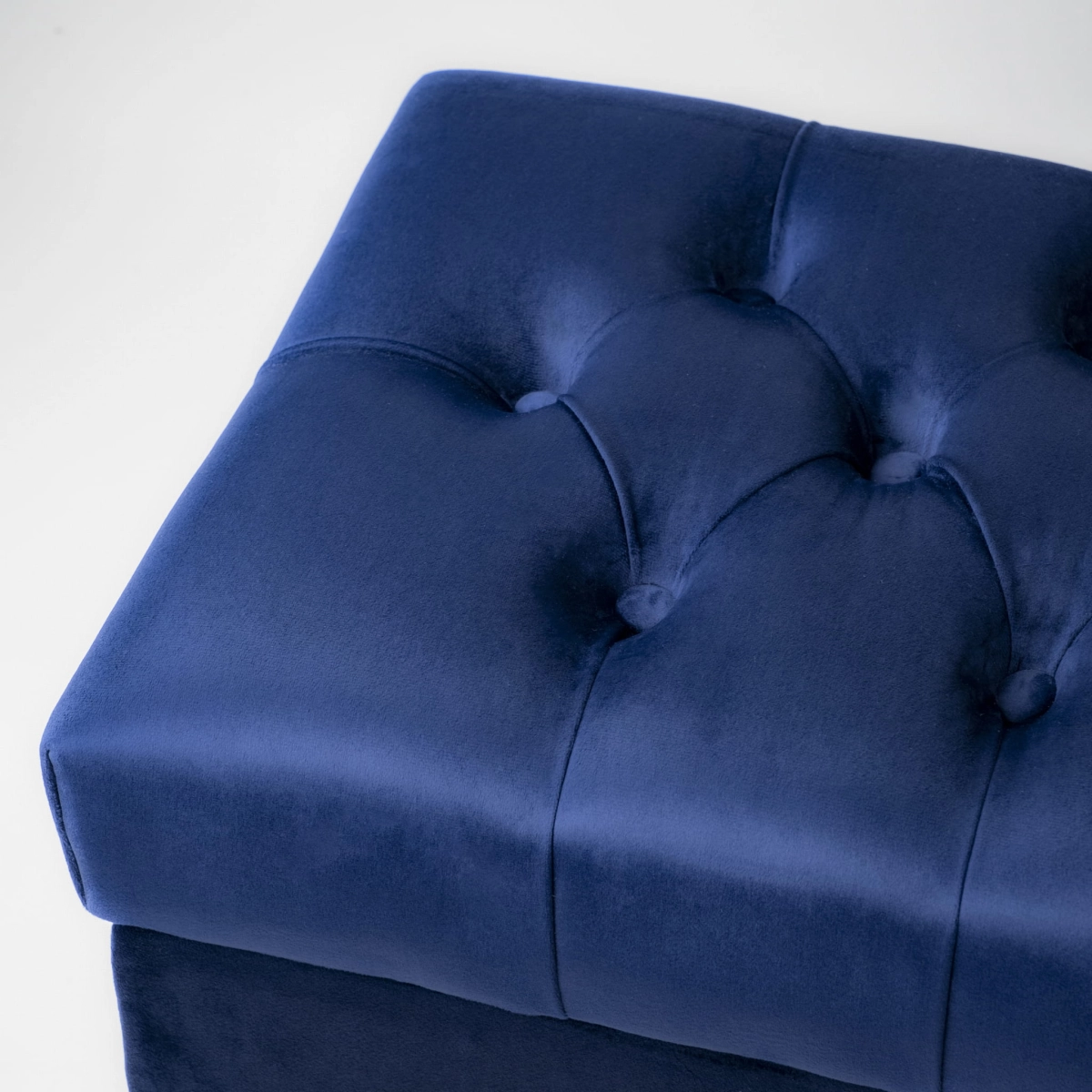Stylish quilted navy blue pouffe with storage compartment