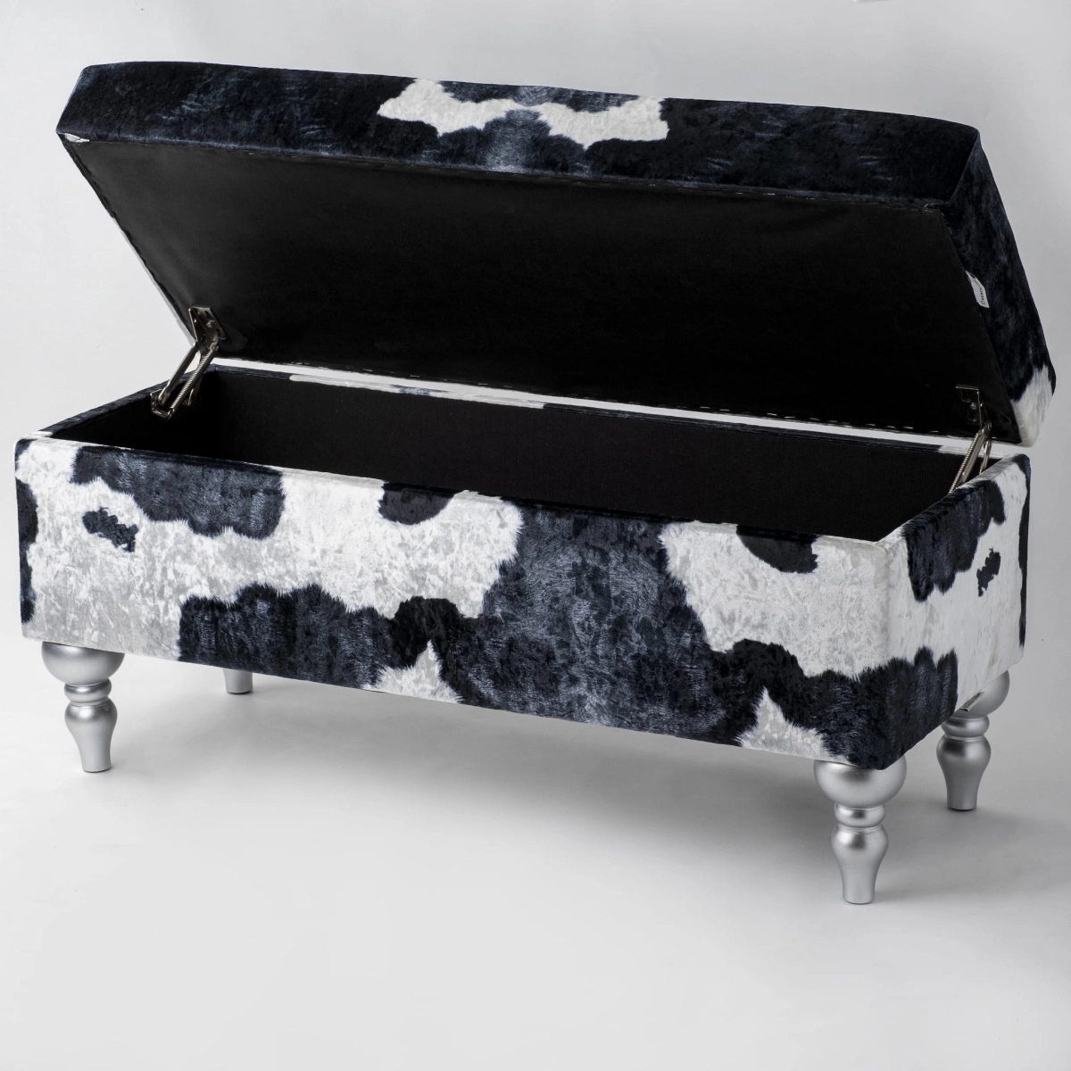 Upholstered pouffe with storage in cow motif