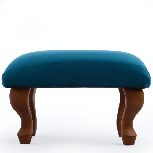 Upholstered footstool in blue, an elegant and practical interior element