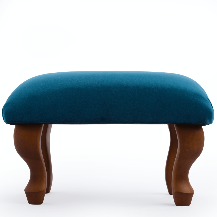 Upholstered footstool in blue, an elegant and practical interior element