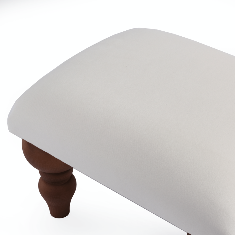 Comfortable white footstool, an elegant addition to a lounge chair
