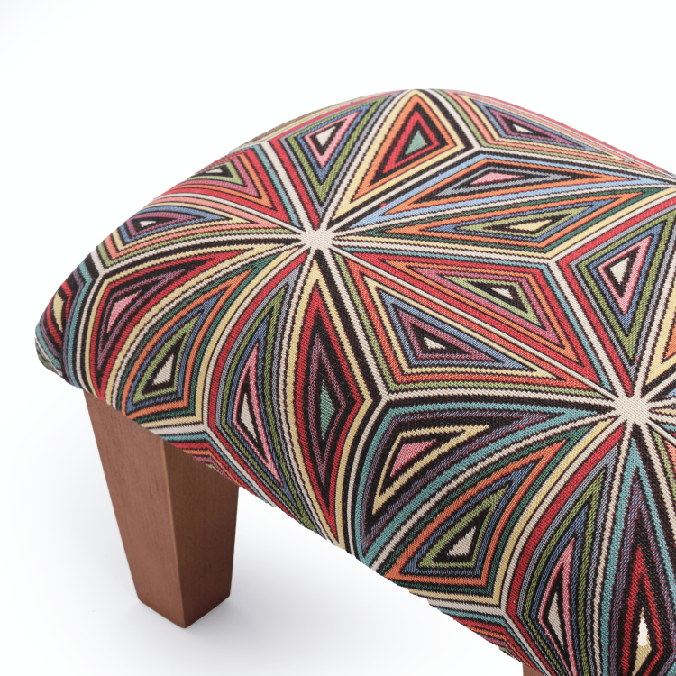 Armchair footstool in bright colours, a comfortable and decorative piece of furniture