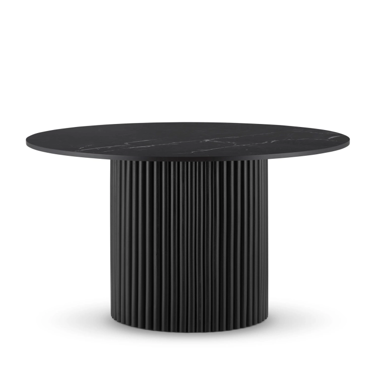 Stylish black table with stone top and grooved base for an elegant interior