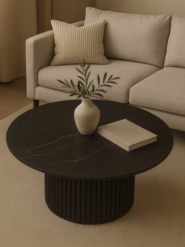Stylish black table with stone top and grooved base for an elegant interior
