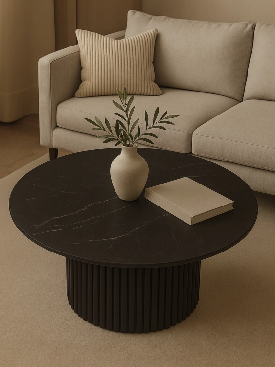 Stylish black table with stone top and grooved base for an elegant interior