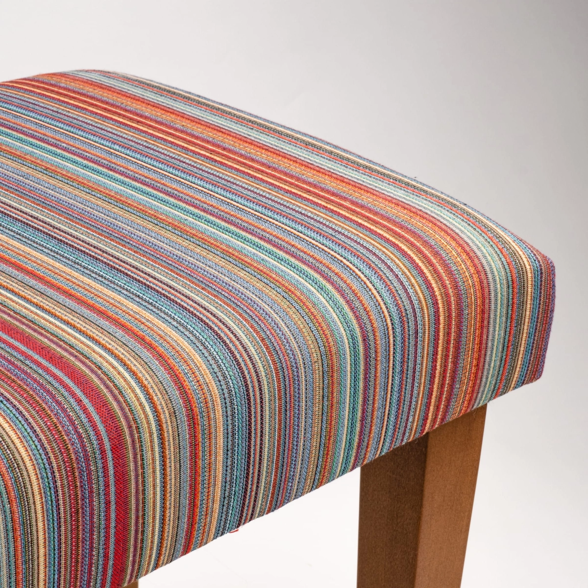 Striped upholstered bench with wooden legs
