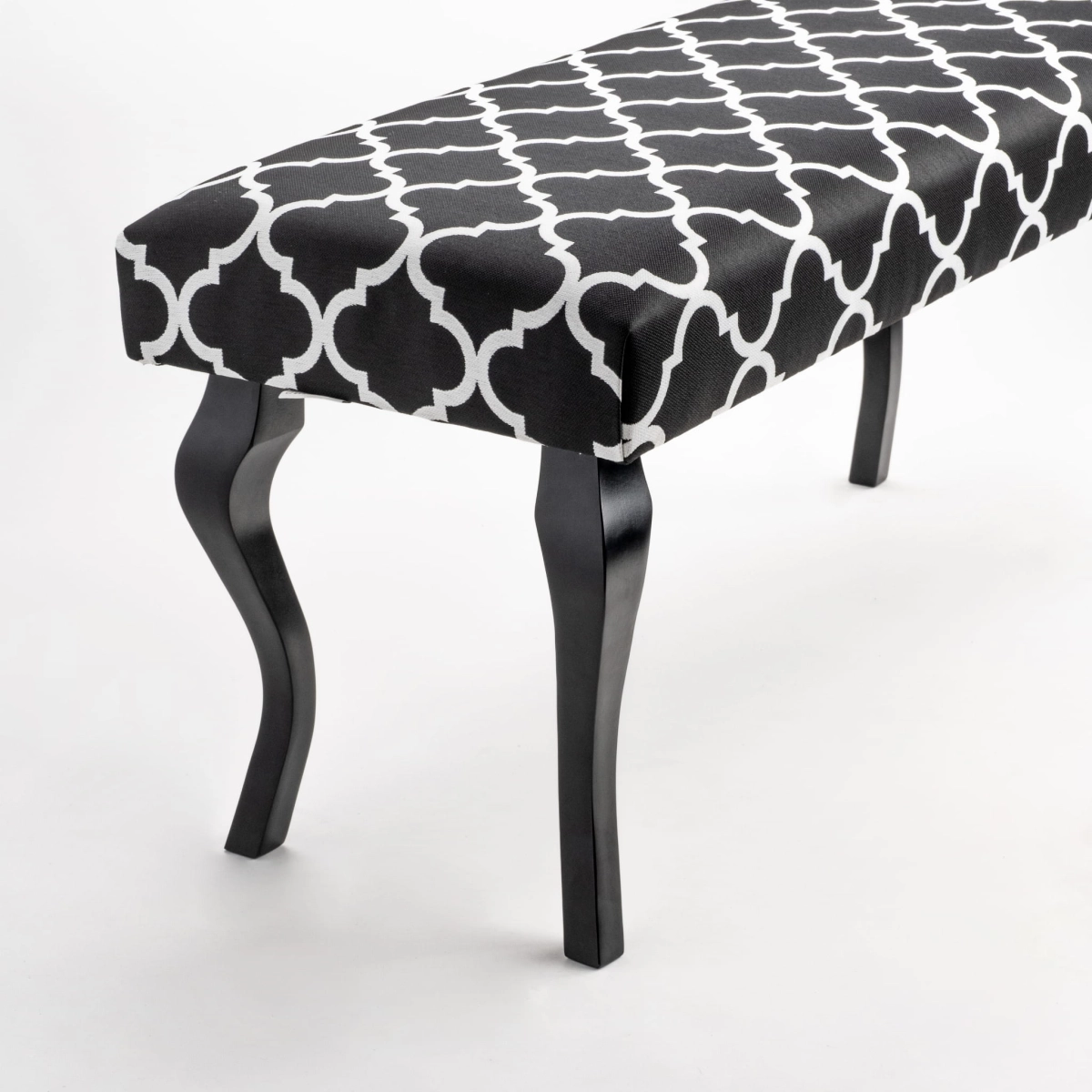 Patterned bench with upholstered seat and black wooden legs