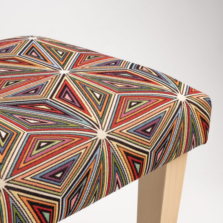 Upholstered patterned bench on wooden legs