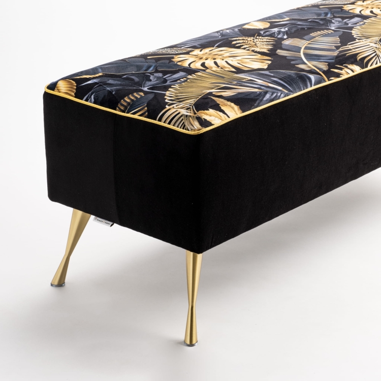 Upholstered bench with gold patterns and metal legs