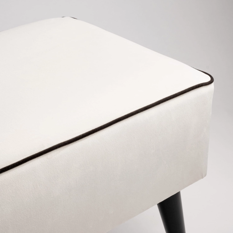 Cream upholstered bench with black legs