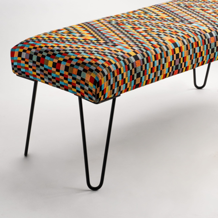 Patterned loft bench with decorative upholstery and thin metal pin legs