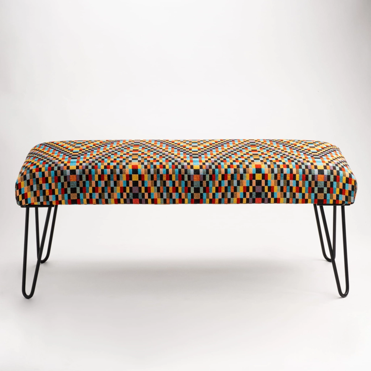 Upholstered industrial bench with colorful pattern and slim pin legs
