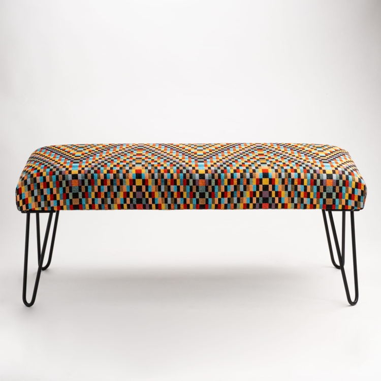 Upholstered industrial bench with colorful pattern and slim pin legs