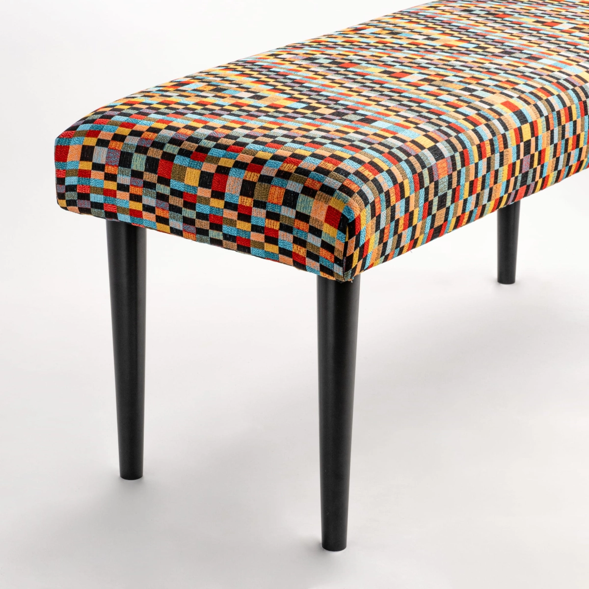 Upholstered bench with black legs and patterned fabric