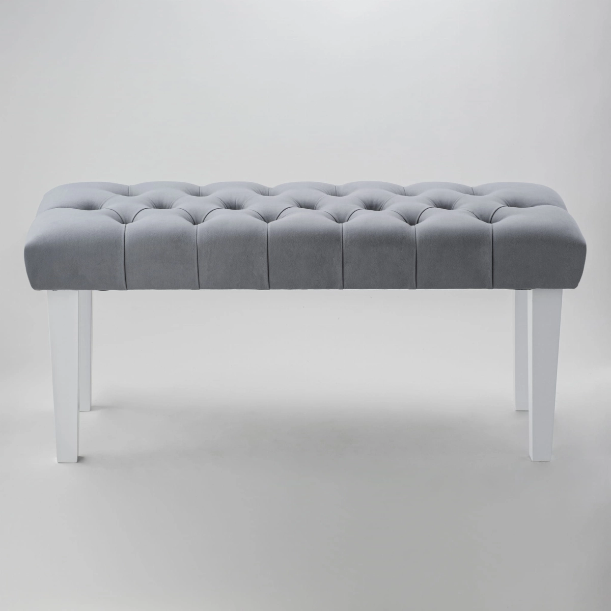 Gray quilted bench with straight white legs