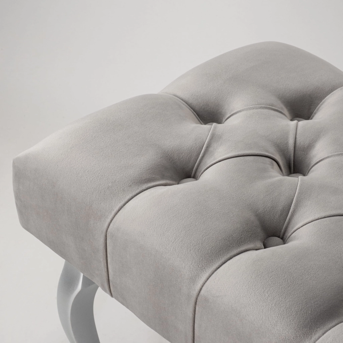 Elegant upholstered grey bench with silver legs