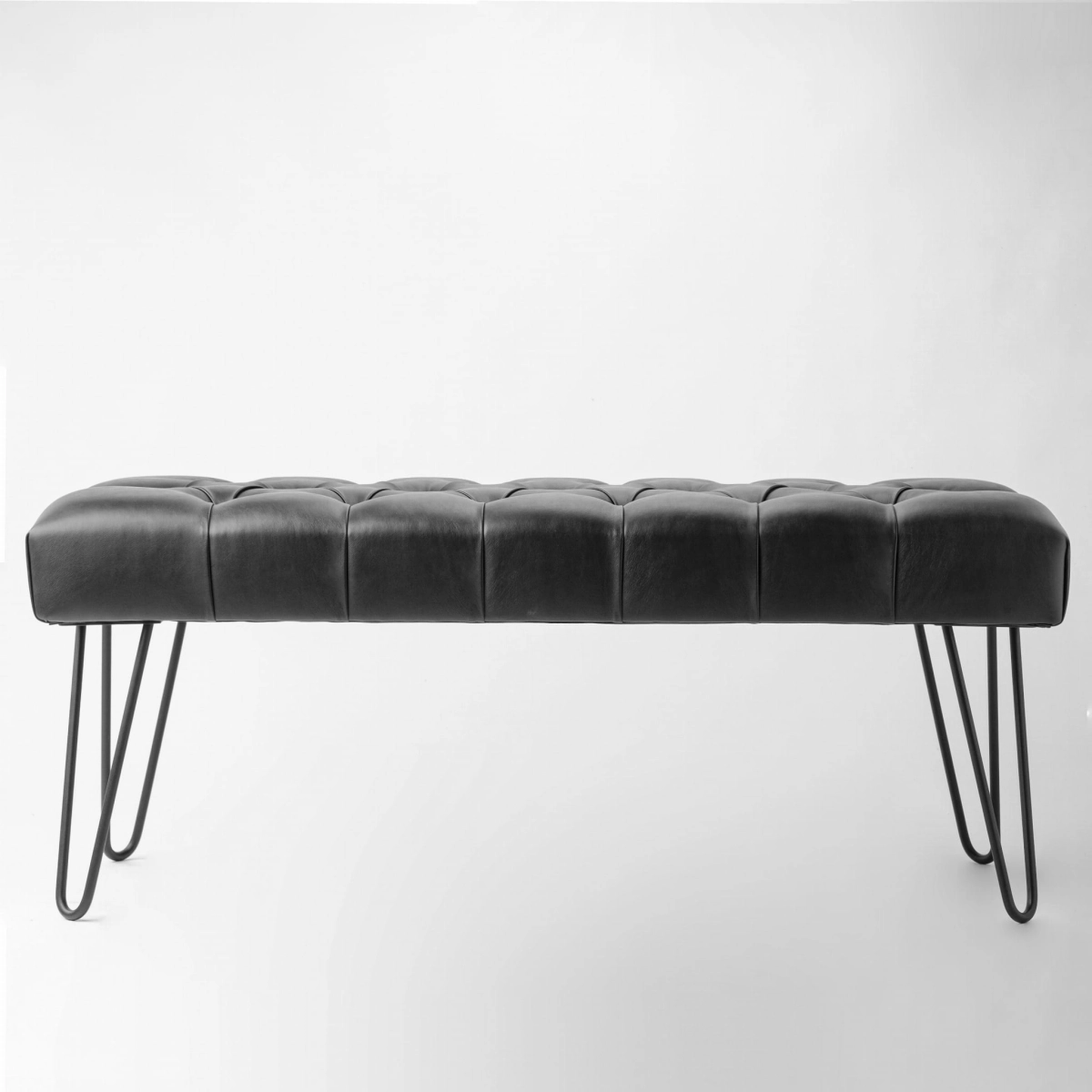 Black leather bench in black on metal legs
