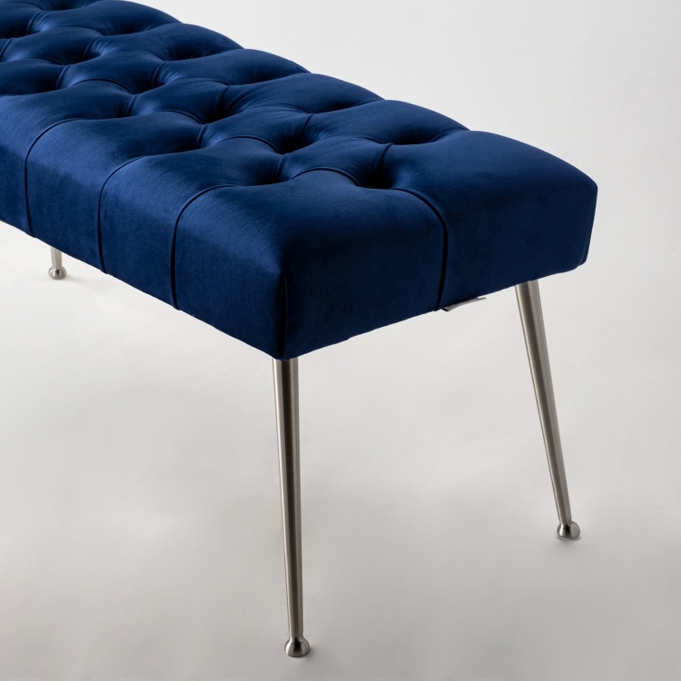 Navy blue quilted bench with metal legs, perfect for loft-style interiors