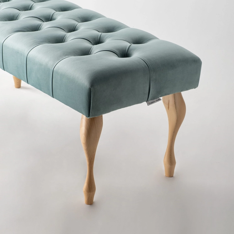 Quilted bench in mint colour with classic wooden legs