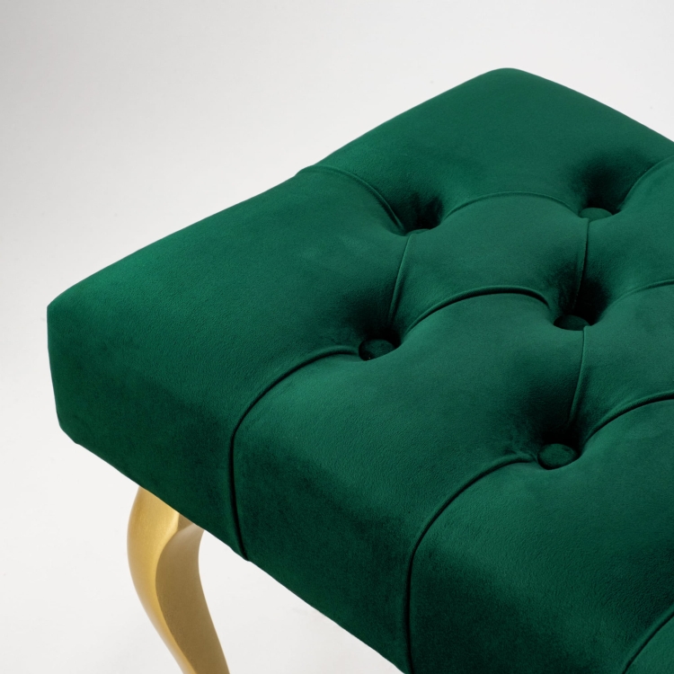 Elegant quilted bench with golden legs in bottle green