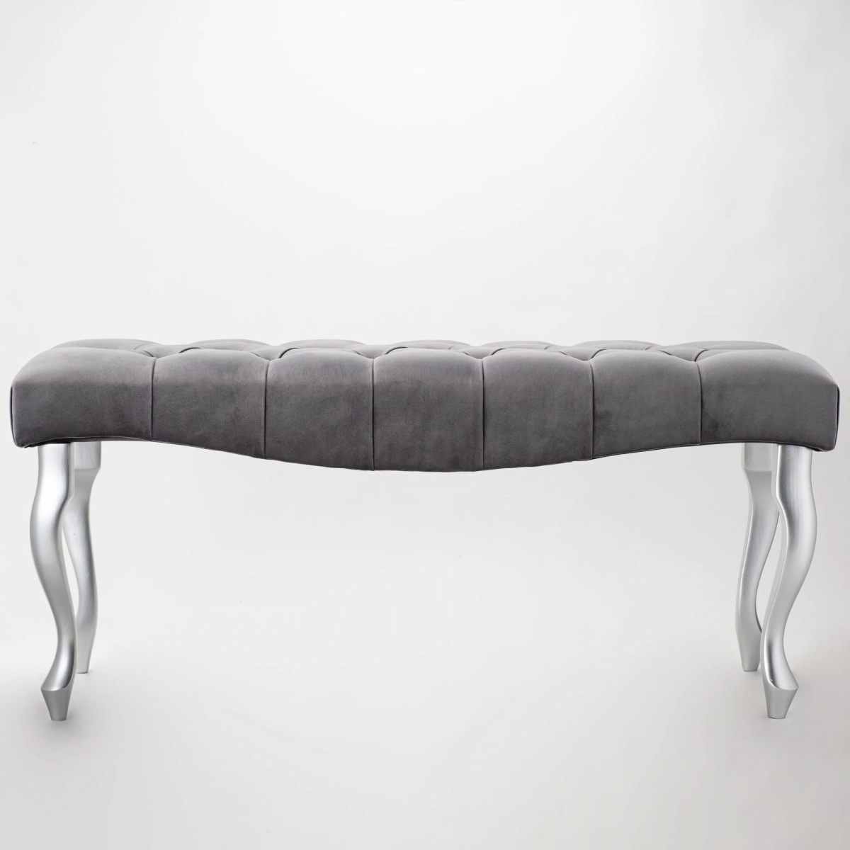 gray bench with a wave-shaped quilted seat