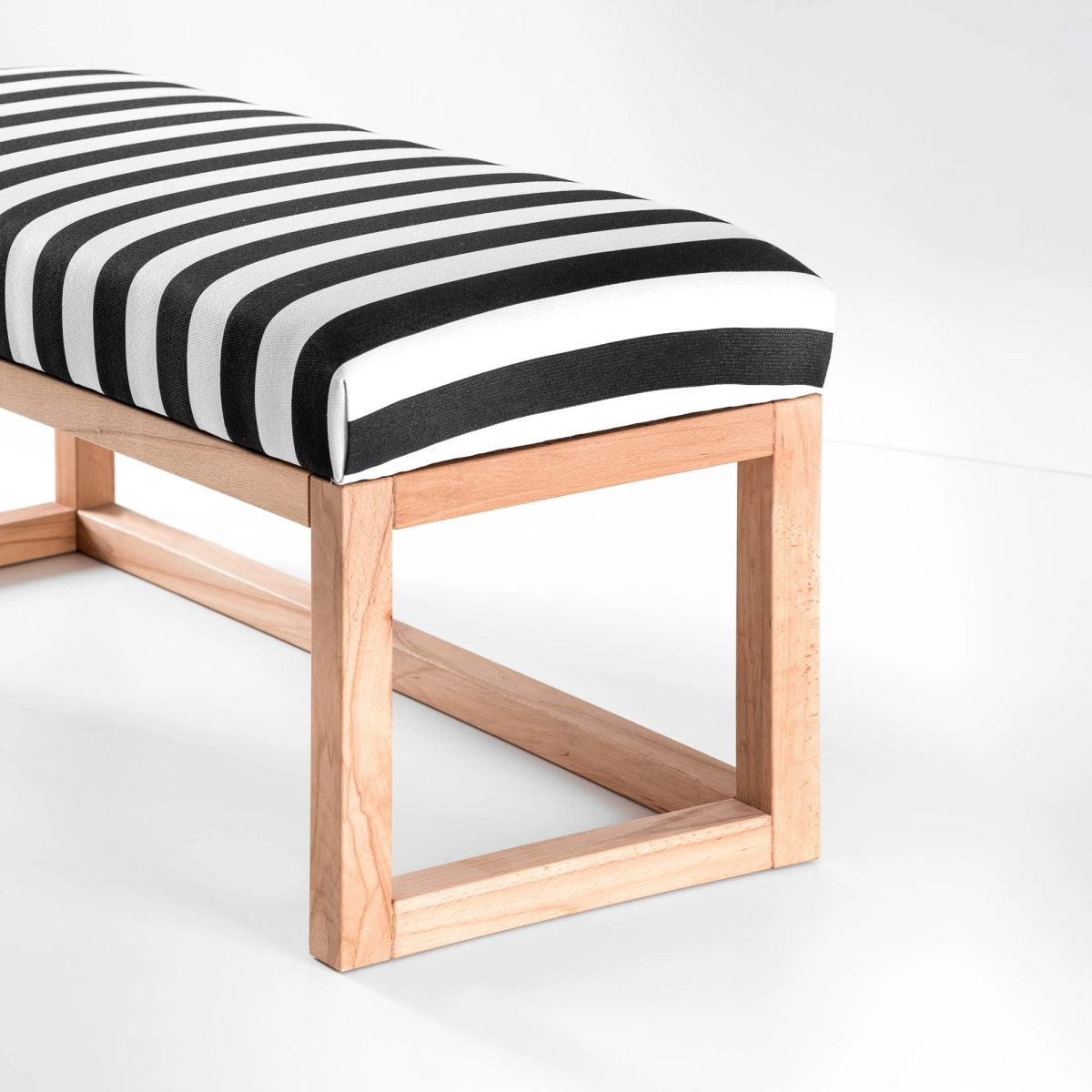 Modern bench with striped upholstery, shelf and wooden frame