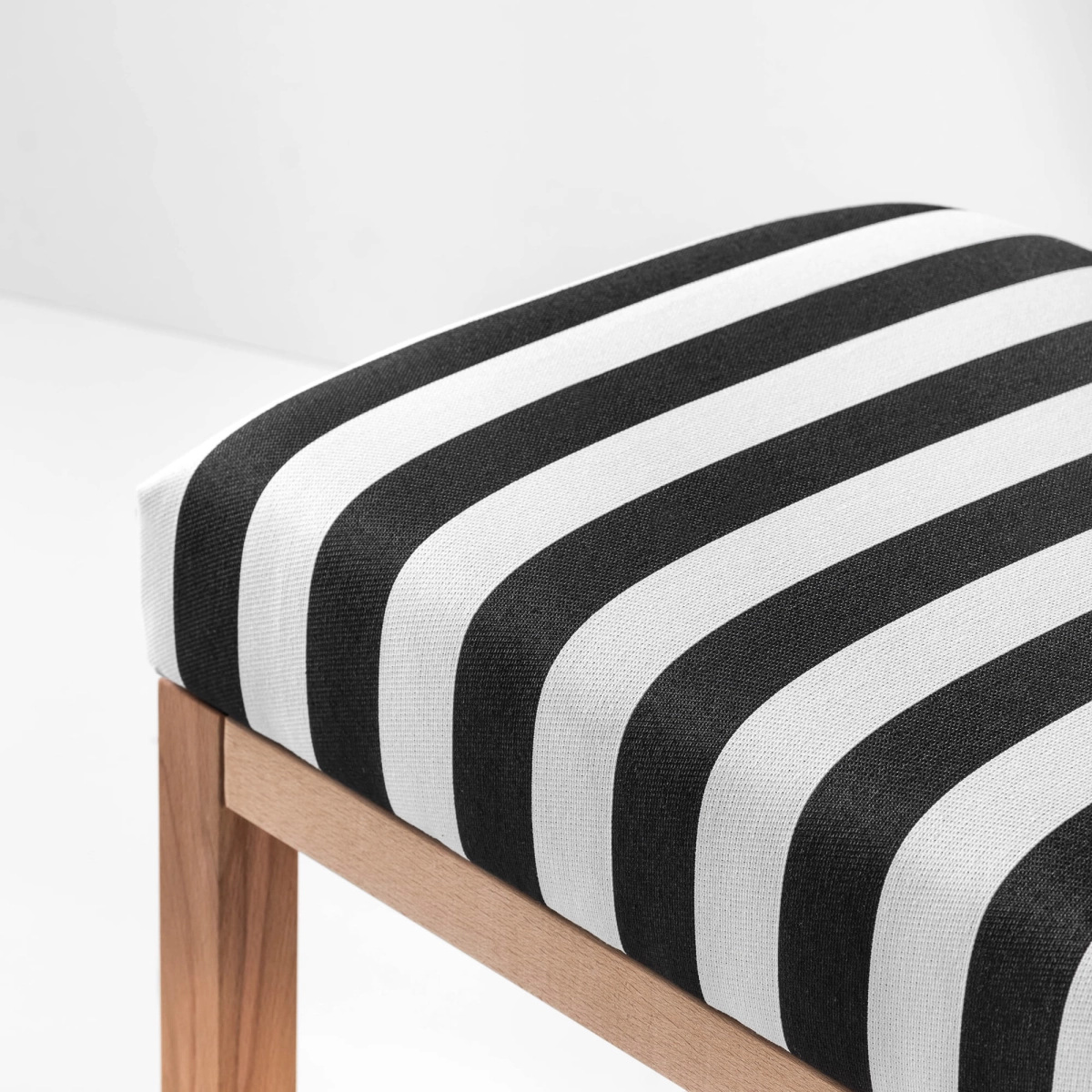 Decorative bench with black and white seat and lower shelf