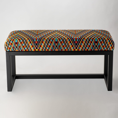 Patterned upholstered bench on metal legs, ideal for loft interiors
