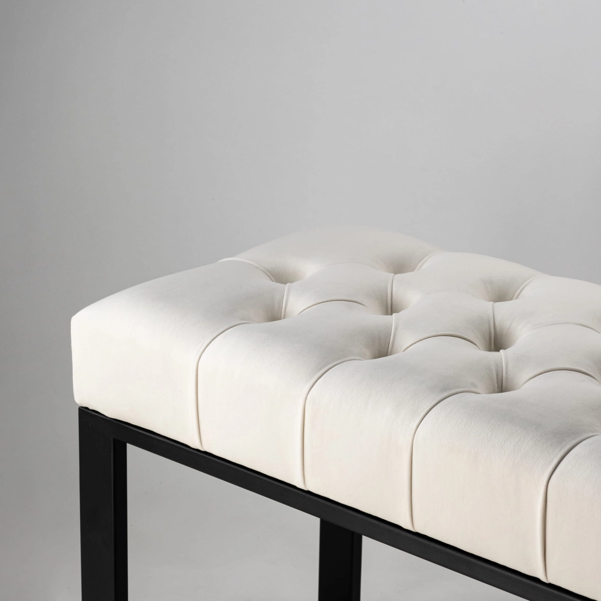 White industrial quilted bench on metal legs