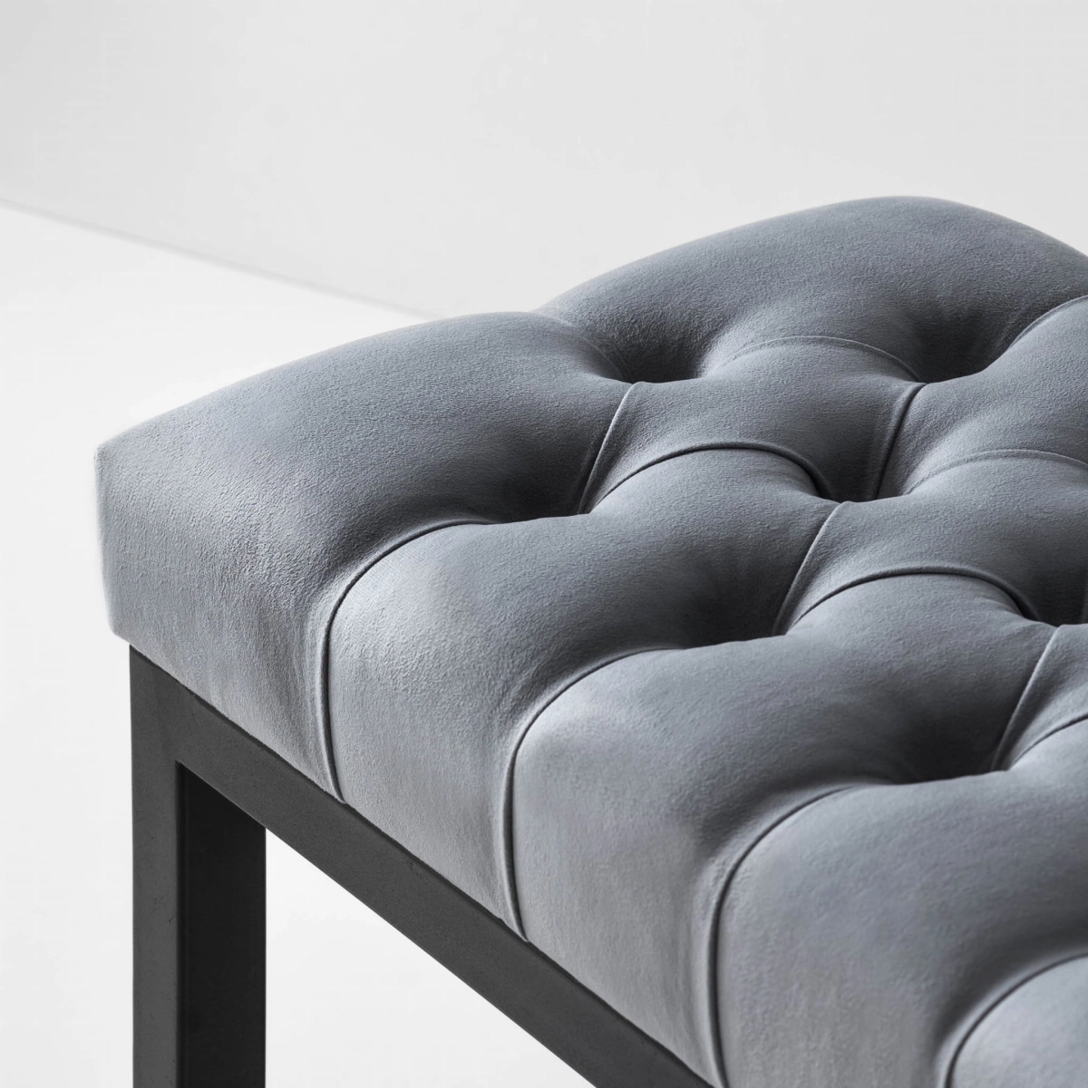 Industrial-style quilted bench on a metal base